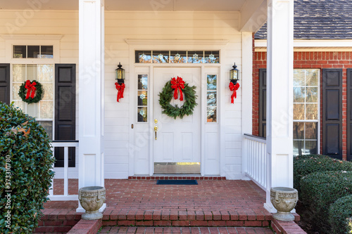 Fotografering Residential home front door decorated for Christmas