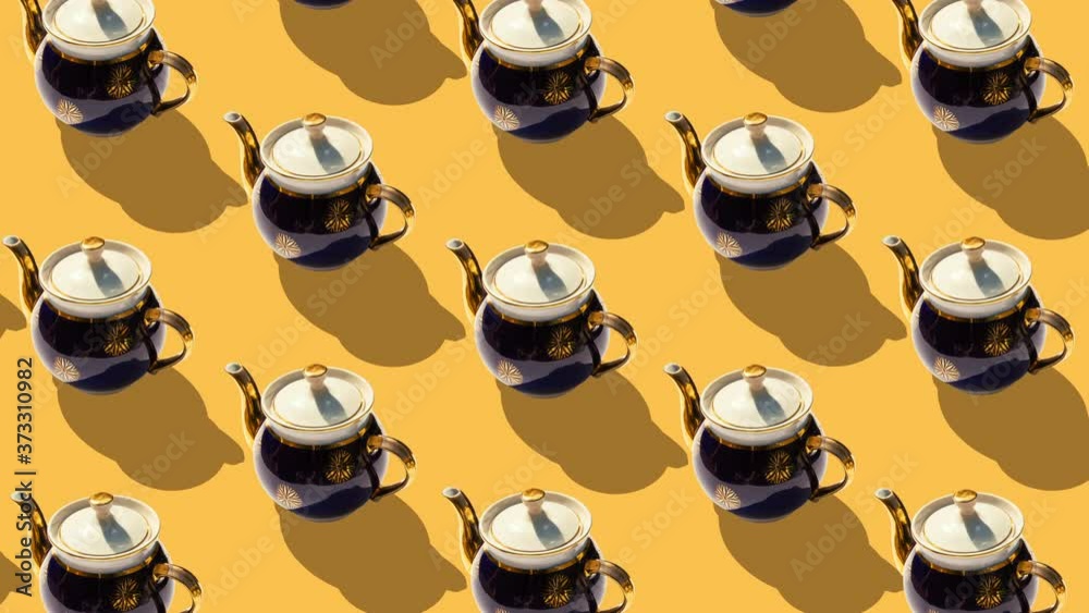 Background from large group of old teapots. Stop motion animation.
Ceramic teapots revolve around their axes.  Flat lay, top view. Diagonal isometric view. Seamless loop video. 