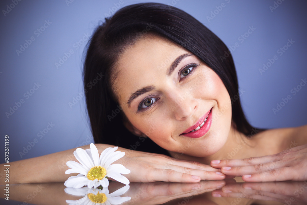 Portrait of smiling brunette woman looking at camera. Beauty concept Portrait of smiling brunette woman looking at camera. Beauty concept