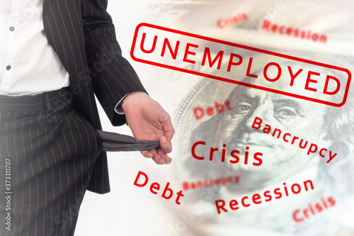 Unemployed. Dismissed man shows empty pocket. Unemployed guy shows consequences of being fired. Empty pocket as a symbol of lack of money. Concept - crisis caused emergence of unemployed.