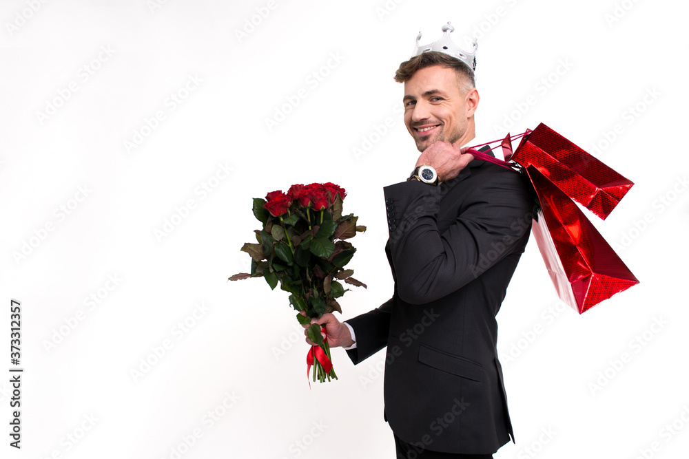Present for his girlfriend. Handsome young man holding roses behind his back and looking at camera with smile while standing against white background
Present for his girlfriend. Handsome young man holding roses behind his back and looking at camera with smile while standing against white background