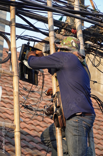 The technician is installing fiber optic for internet network. 