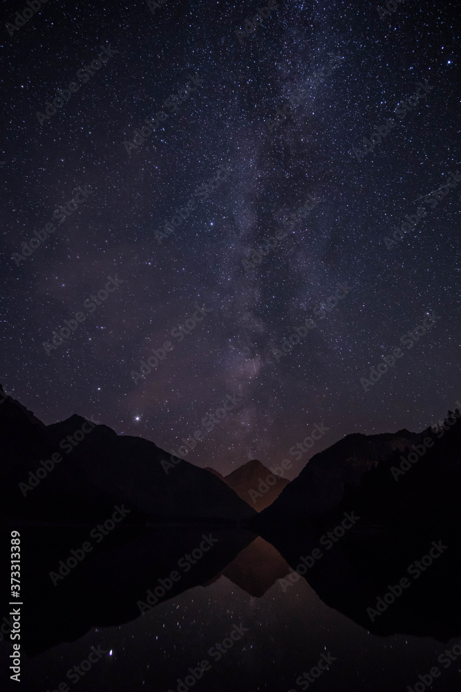 Plansee and mountains with milky way in Reutte, Austria 