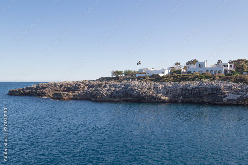 Mediterranean Sea coast with houses on rocks in the sunny summer of the island of Majorca in Spain