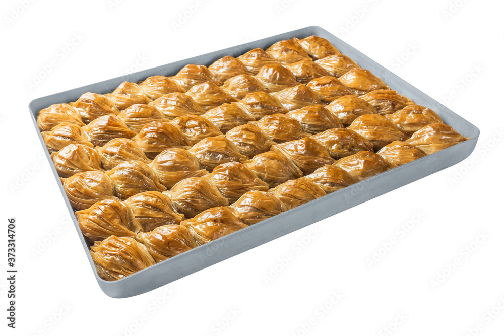 Turkish baklava, oriental sweets on a metal tray, isolated on white background. Horizontal format. Turkish baklava, oriental sweets on a metal tray, isolated on white background. Horizontal format.