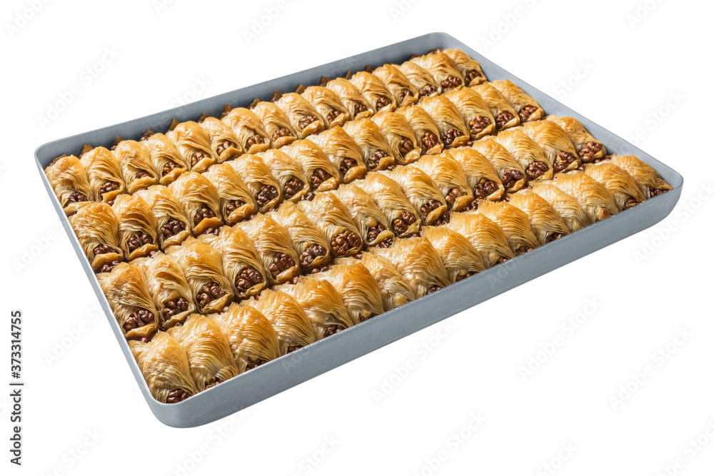 Turkish baklava, oriental sweets on a metal tray, isolated on white background. Horizontal format. Turkish baklava, oriental sweets on a metal tray, isolated on white background. Horizontal format.