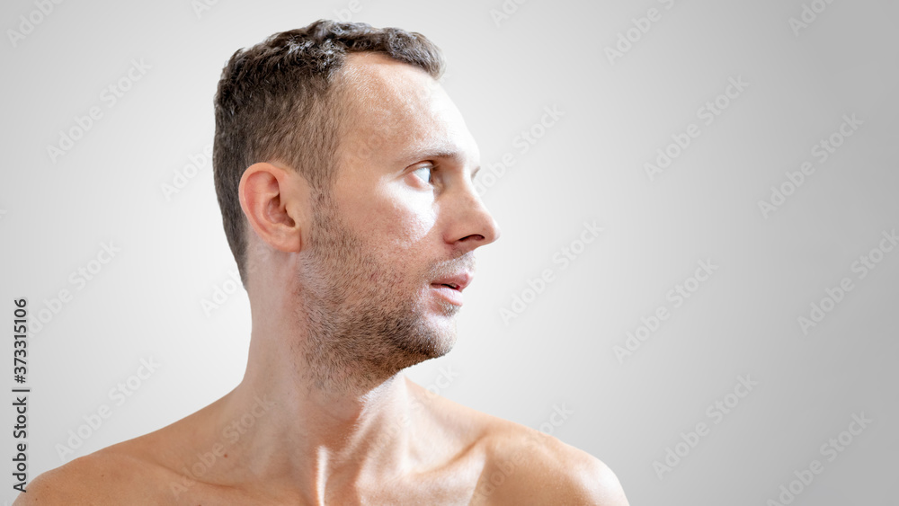Obraz premium close-up profile portrait of a young white male with a naked torso with copy space