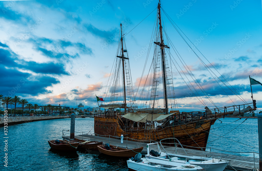 Recreational pirate ship in Portimao. Beautiful old ship that docks in the port of Portimao. Organize excursions for tourists. Made of wood, and with two masts, it transports us to the times of ancien