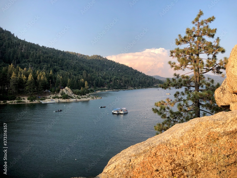 A view from the cliffs above Big Bear Lake, of a sandy beach in the distance.