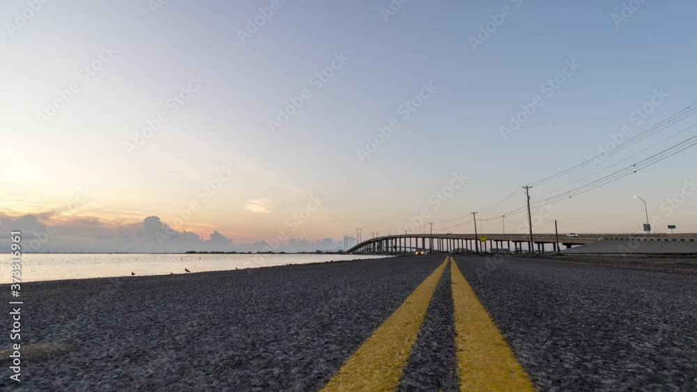 Low Angle View of Road Leading to Coastal Bridge During Sunrise