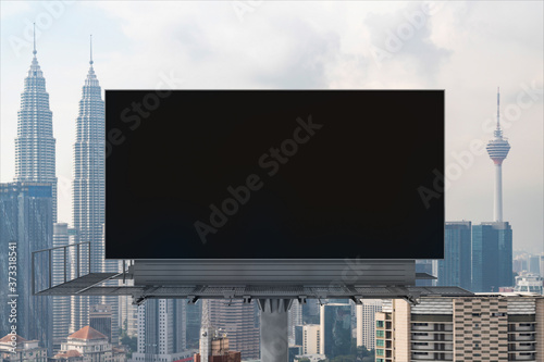 Canvas Print Blank black road billboard with Kuala Lumpur cityscape background at day time