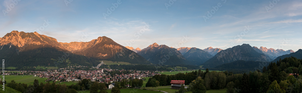 Panorama from the town Oberstdorf in Germany with the mountains in the background at sunset.