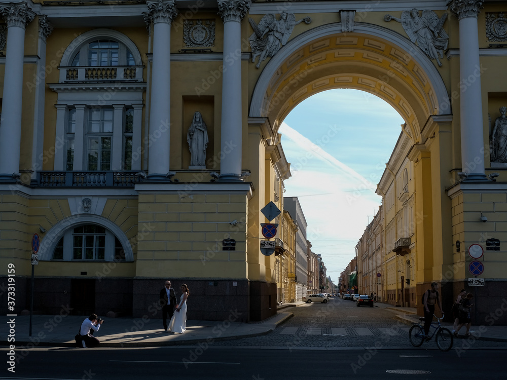 22 of July 2020 - St.Petersburg, Russia: Photographer taking pictures of newlyweds on the embankment of St. Petersburg