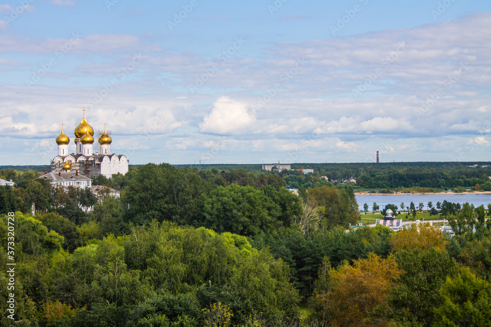 Fototapeta premium panoramic view of the old city with historical architecture against a blue sky with white clouds on a clear summer day and space for copying in Yaroslavl Russia