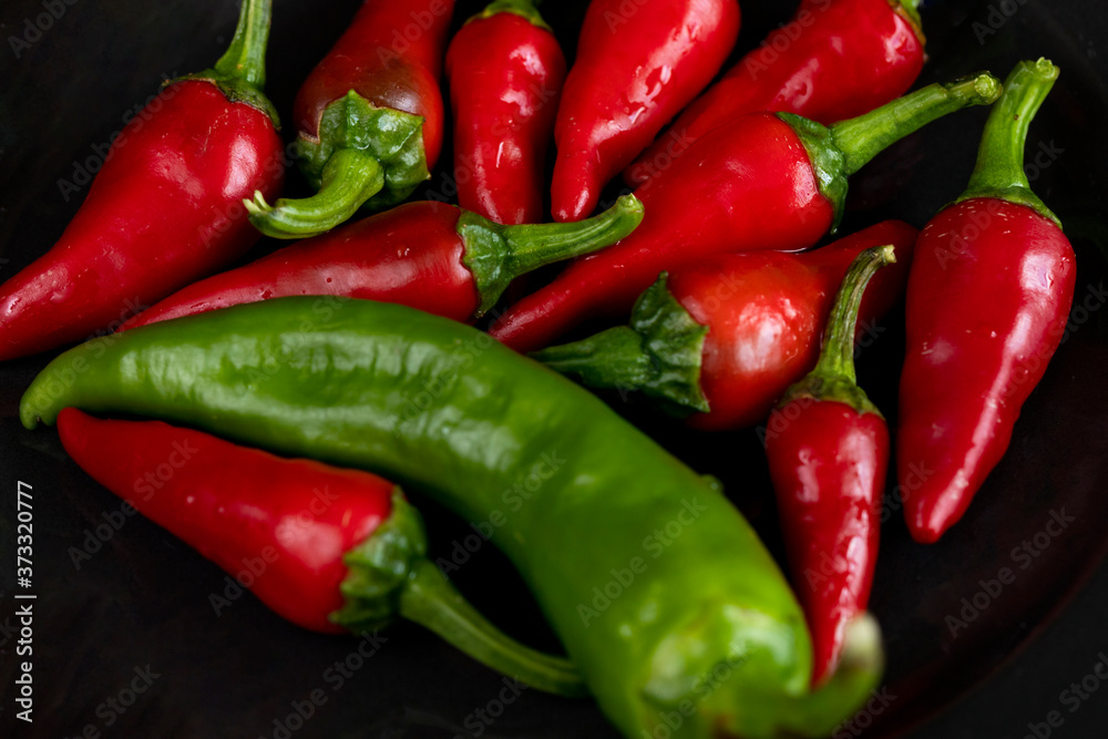 Group of Red hot chilli peppers close-up on a dark backgroundм