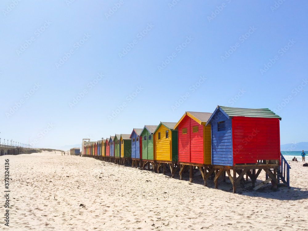 Naklejka premium colorful beach houses on the beach at Muizenberg in side perspective - South Africa, Eastern Cape