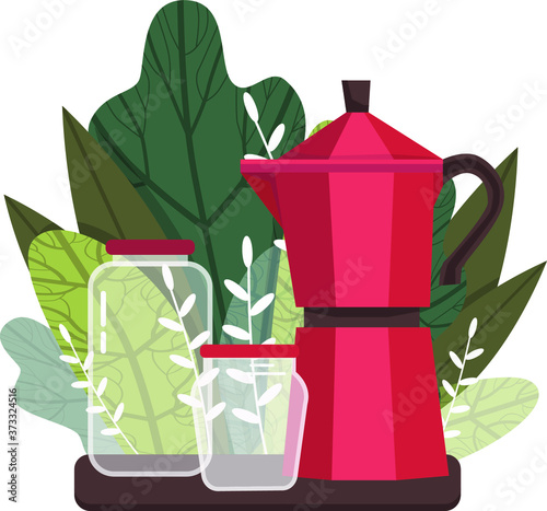 coffee maker with cans on a background of leaves