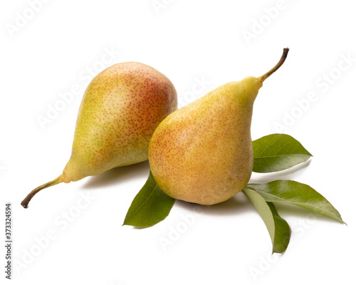 Two ripe pears with green leaf on white background.