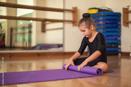 Kid at gymnastic class doing exercises. Children and sport concept