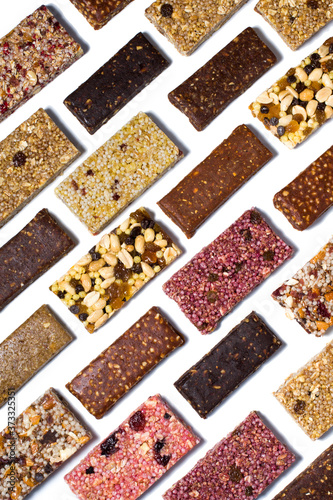 Flat lay composition with cereal granola and protein bars with nuts and dry fruit berries on the white backround