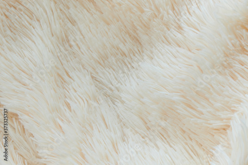 delicate soft background of plush fabric folds on white background. Copy space. Flat lay. loose folds on the fabric of faux fur of lilac color. Details of warm winter clothes