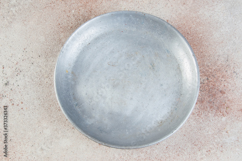 Old metal plate for scales on concrete background.