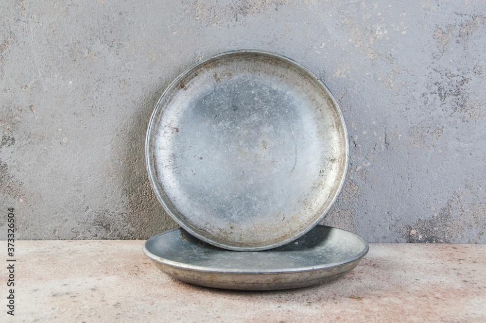 Old metal plates for scales on concrete background. Old metal plates for scales on concrete background.