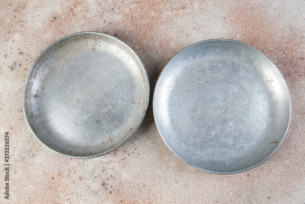 Old metal plates for scales on concrete background.