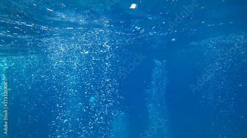 Fethiye, Turkey - 30th of July 2020: 4K Thousands of air bubbles rising and meeting surface as shot underwater
