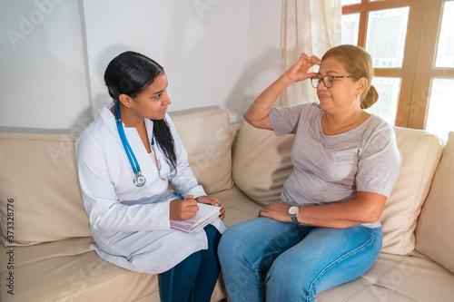 Older Hispanic woman and doctor in a medical office
