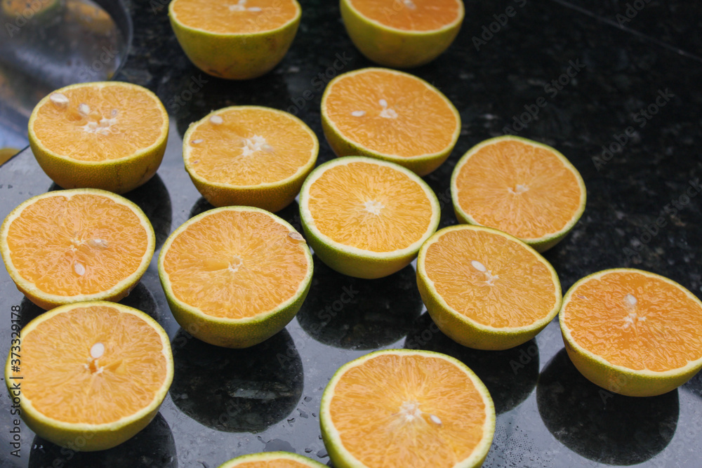 oranges for juice on dark granite countertops, space for writing oranges for juice on dark granite countertops, space for writing