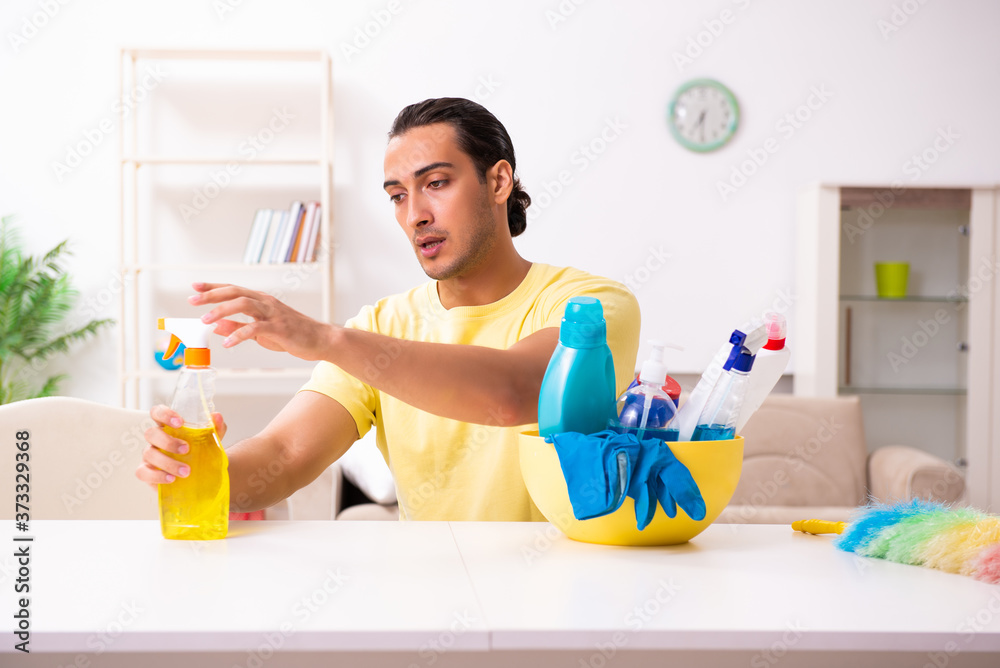 Young male contractor doing housework at home
