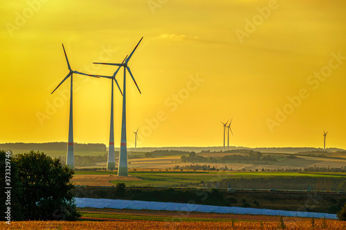 wind turbines and modern solar panels in the rural landscape
