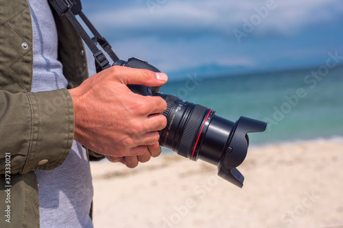 man is holding an  photocamera