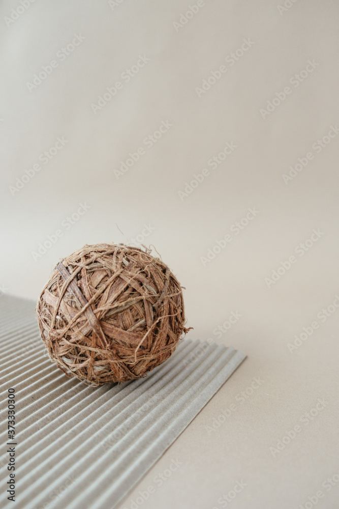 Handmade home decor. Ball on beige background of corrugated paper. Handmade home decor. Ball on beige background of corrugated paper.
