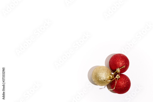 Christmas tree toys isolated on a white background. Three new year glitter balls red and gold color. Festive banner with place for text in fashion style.