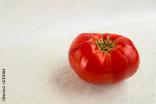 Big ugly tomato on a white background.