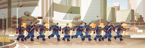 policemen with shields and batons riot police officers standing together protesters demonstrations control concept cityscape full length horizontal vector illustration