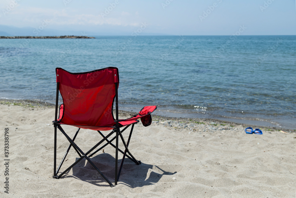 Red camp comfortable chair near the seaside. A beautiful sea view from Black sea Turkey. Red camp comfortable chair near the seaside. A beautiful sea view from Black sea Turkey.