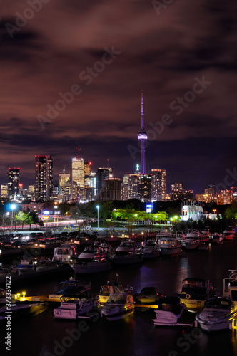 Cityscape of Toronto at night with moored boats at Ontario Place marina