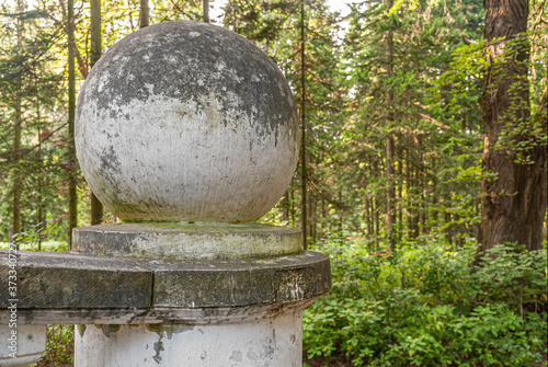 stone sphere on a parapet in a park