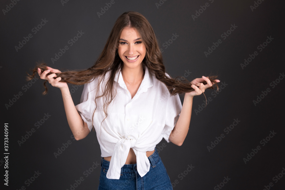 Long hair ends problems, girl holding her hair, happy and unhappy with her hair quality, isolated on dark background Long hair ends problems, girl holding her hair, happy and unhappy with her hair quality, isolated on dark background
