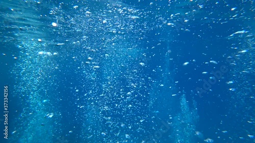 Fethiye, Turkey - 30th of July 2020: 4K Thousands of air bubbles rising and meeting surface as shot underwater
