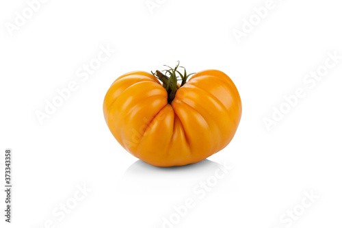 Large yellow tomato in the shape of heart isolated