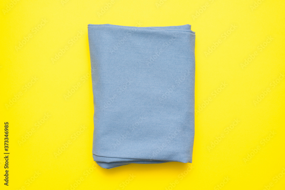 Blue tissue on the yellow flat lay background. Blue tissue on the yellow flat lay background.