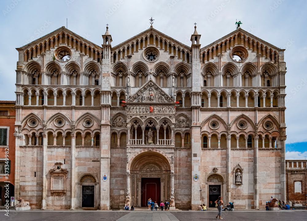 Marble façade of the Cathedral of Ferrara, Emilia Romagna region, Italy, built in the 12th century and decorated with statues and niches.