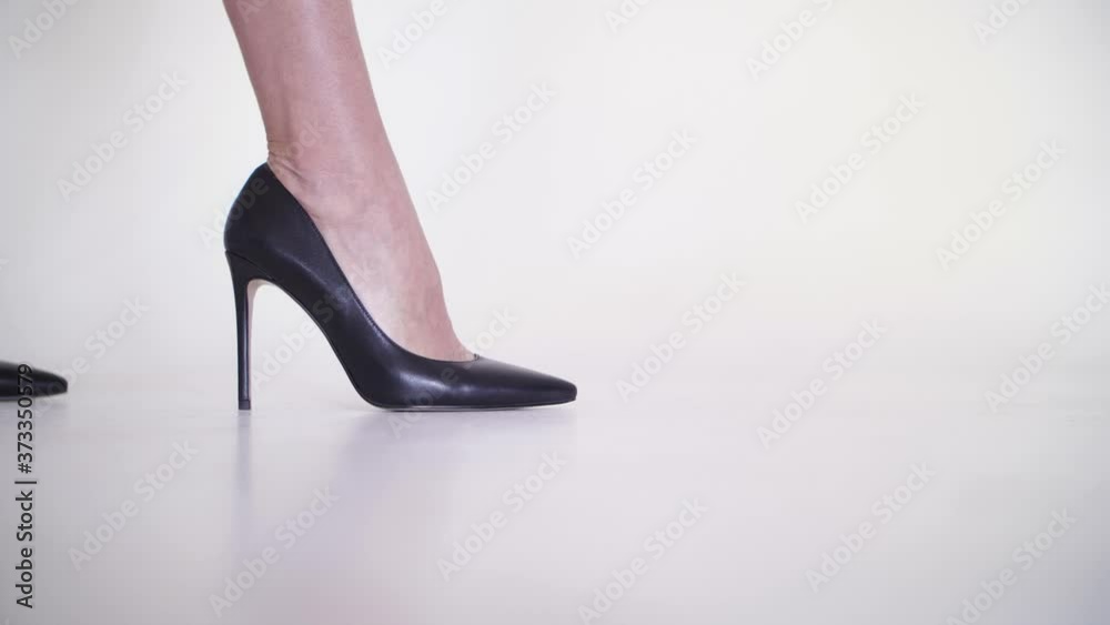 female legs in black shoes enter the frame, turn to the camera and make a cross female legs in black shoes enter the frame, turn to the camera and make a cross