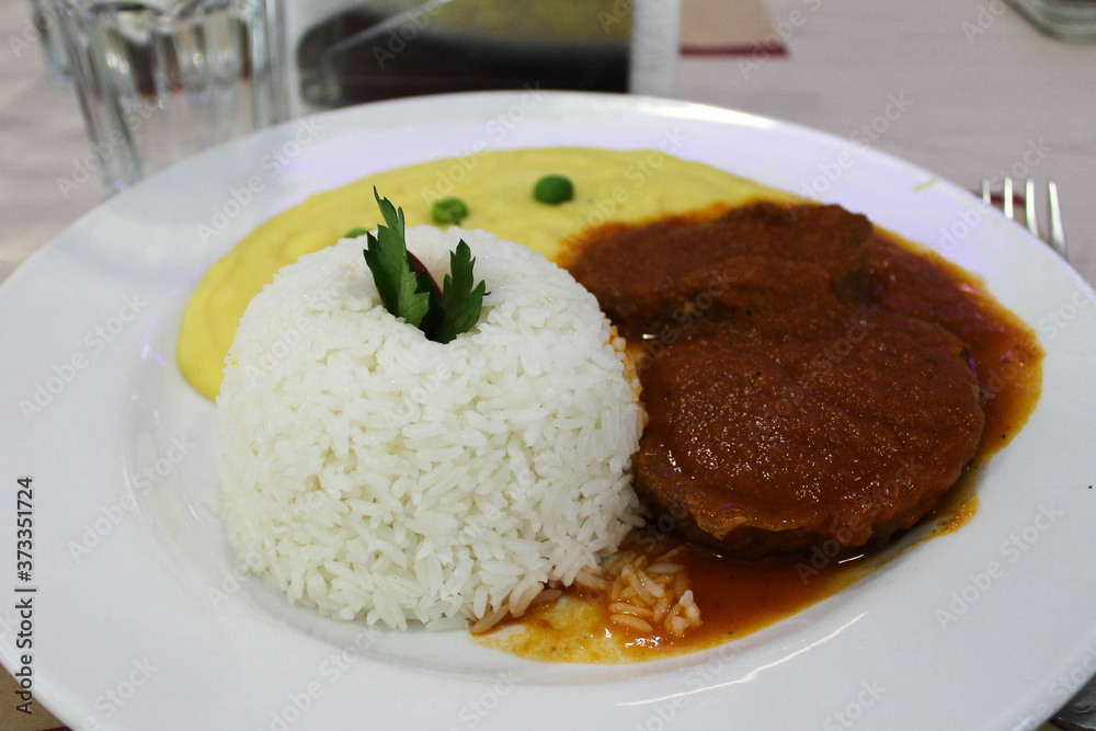 Roast with a rice, a typical Peruvian dish.