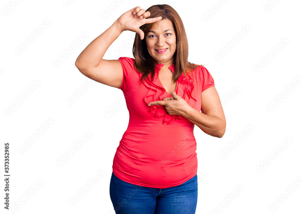 Middle age latin woman wearing casual clothes smiling making frame with hands and fingers with happy face. creativity and photography concept. Middle age latin woman wearing casual clothes smiling making frame with hands and fingers with happy face. creativity and photography concept.