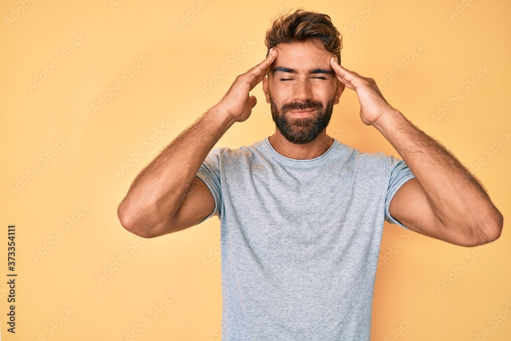 Young hispanic man wearing casual clothes suffering from headache desperate and stressed because pain and migraine. hands on head. Young hispanic man wearing casual clothes suffering from headache desperate and stressed because pain and migraine. hands on head.